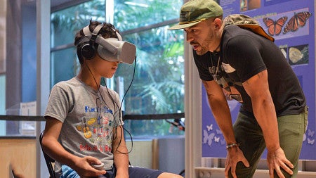 Danny working with a child in virtual reality lab