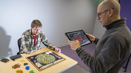 UOregon grad student leads peer in playing climate change board game