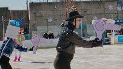 Armed with cardboard hair dryers, performers act out melting a glacier in the Bearded Ladies' climate change themed drag show on ice at the RiverRink. Photo credits: Emma Lee/WHYY