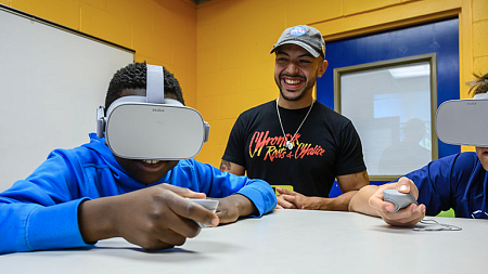 A researcher working with students in virtual reality