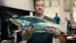 Lummi artist and Season 3 'Blown Away' contestant Dan Friday displays glass art of a fish. 