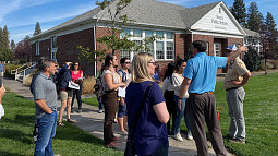 Students in the Sustainable City Year program meet with community partners in front of the Sisters Public School in Sisters, Oregon. 