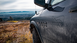 An OHAZ logo adorns the driver-side door of a black Dodge Ram 1500 pickup truck