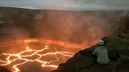 Brittany Erickson, an assistant professor in the Department of Computer and Information Science who studies geophysics and is a colleague of UO’s Leif Karlstrom, peers into the Halema'uma'u lava lake on Hawai’i’s Kiīlauea volcano.